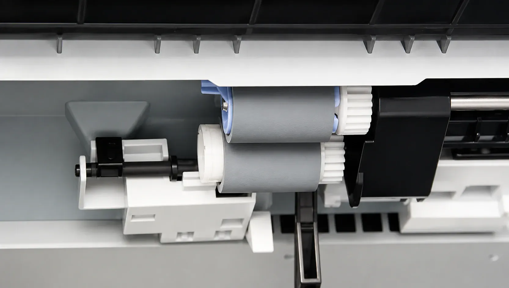 Worn pickup and feed rollers to be removed from an HP LaserJet paper tray during a no-pick jam repair